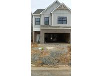 Charming two-story home featuring a light gray exterior, black framed windows, and a bricked two-car garage at 1075 Crest Mill Dr, Marietta, GA 30008