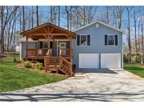 Charming blue two-story home with a covered porch and a two-car garage at 2958 Forelock Sw Pl, Marietta, GA 30064