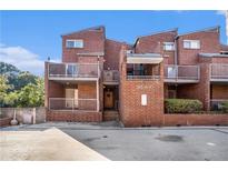 Brick townhouse complex with balconies, landscaping, and easy access to parking in a vibrant neighborhood at 385 Ralph Mcgill Ne Blvd # D, Atlanta, GA 30312
