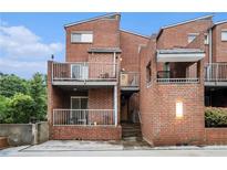 Brick townhouse with balconies on a sunny day showcasing its unique architectural design and urban living at 385 Ralph Mcgill Ne Blvd # D, Atlanta, GA 30312