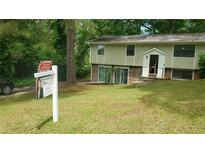 Split level home with lawn and stone accents at 4690 Big Valley Ct, Stone Mountain, GA 30083