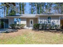 Charming single-story home featuring a well-maintained lawn and inviting front entrance at 1780 Brewer Sw Blvd, Atlanta, GA 30310