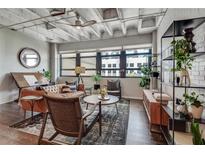 Contemporary living room featuring exposed ceiling, hardwood floors, and lots of natural light at 878 Peachtree Ne St # 535, Atlanta, GA 30309