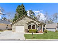 Charming single-story home featuring manicured lawn, attached garage and inviting front entrance with a decorative wreath at 4062 Wildflower Ln, Tucker, GA 30084