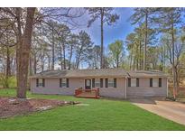 Charming single-story home featuring a manicured lawn and welcoming front porch at 3618 Mansfield Ln, Snellville, GA 30039