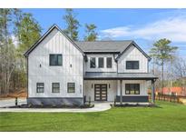 Charming two-story home with white siding, dark accents, covered porch, and a well-manicured lawn at 5185 Cascade Rd, Atlanta, GA 30331