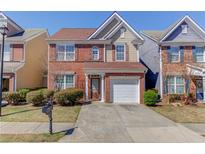 Charming two-story brick home with well-maintained landscaping and an attached single-car garage at 1554 Park Grove Dr, Lawrenceville, GA 30046