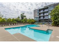 Beautiful condo complex featuring a sparkling pool, lounge chairs, and lush green landscaping perfect for relaxation at 130 Arizona Ne Ave # 302, Atlanta, GA 30307