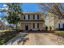 Charming two-story home featuring a well-maintained lawn, a concrete driveway, and classic black shutters at 201 Coral Cir, Mcdonough, GA 30253