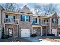 Charming townhome featuring a brick facade, balconies, and attached garage in a desirable neighborhood at 2544 Castellan Dr, Atlanta, GA 30316