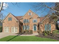 Traditional brick home featuring a two-car garage, manicured lawn, and mature trees providing shade at 1625 Unity Loop, Cumming, GA 30040
