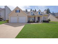 Charming one-story home with a well-maintained lawn and two-car garage at 5016 Larkspur Ln, Atlanta, GA 30349