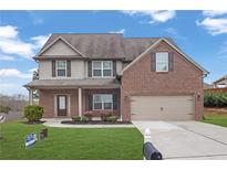Charming two-story home featuring a brick and siding exterior with a well-manicured front yard at 5414 Splendida Ct, Fairburn, GA 30213