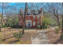Stately brick home with dormer windows and a manicured front yard at 1305 Fairview Ne Rd, Atlanta, GA 30306