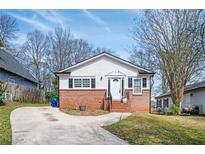 Charming single-story home with a brick facade and a well-manicured lawn and a curved driveway at 3162 Alston Dr, Decatur, GA 30032
