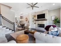 Inviting living room with a fireplace, built-in shelving, and open access to the dining area and kitchen at 345 Glen Iris Ne Dr # 5, Atlanta, GA 30312