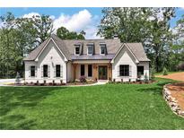 Charming white brick home with a manicured lawn and inviting curb appeal at 6110 Harvest Way, Cumming, GA 30028