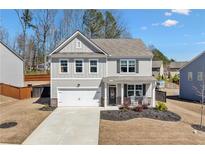Charming two-story home with a well-manicured lawn and a welcoming front porch at 311 Ivy Chase Loop, Dallas, GA 30157