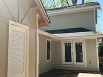 The home's exterior features a cozy patio with double doors and light colored siding at 6405 Cherry Tree Ln, Atlanta, GA 30328