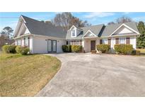 Charming one story home with manicured landscaping and a horseshoe driveway at 1321 Stoneleigh Dr, Conyers, GA 30094