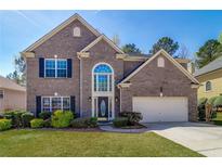 Charming two-story brick home with a well-manicured lawn and inviting curb appeal at 2848 Stockbridge Way, Dacula, GA 30019