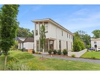 Modern two-story home with clean lines, complemented by landscaped front yard and gravel walkway at 370 2Nd St, Fayetteville, GA 30214
