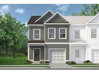New two-story home featuring vertical siding, an attached garage, and a well-manicured lawn and landscaping at 40 Alameda St # 131, Loganville, GA 30052