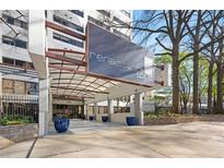 Renaissance Lofts building entrance with modern awning, blue planters, and manicured landscaping at 120 Ralph Mcgill Ne Blvd # 312, Atlanta, GA 30308