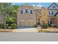 Charming brick front exterior with a two-car garage and well-maintained landscaping at 189 Privet Cir, Suwanee, GA 30024