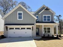 Charming two-story home featuring a two-car garage, stone accents, and gray siding at 2955 Jefferson St, Austell, GA 30106