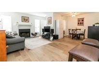 Inviting living room featuring a cozy fireplace, wood flooring, and a comfortable seating area at 1325 Branch Dr, Tucker, GA 30084