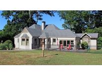 Charming single-story home with a manicured lawn and a classic iron fence surrounding the perimeter at 584 Cherokee Ne St, Marietta, GA 30060