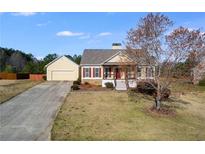 Charming single-Gathering home with a well-maintained lawn and a detached two-car garage at 363 Safe Harbor Dr, Dallas, GA 30157