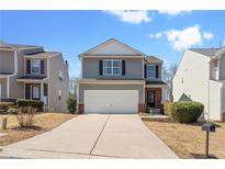 Charming two-story home featuring a two-car garage and a well-manicured front lawn at 2845 Englewood Dr, Cumming, GA 30040
