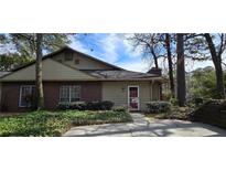 Charming brick and siding home with well-maintained landscaping and mature trees at 4858 Westridge Dr, Norcross, GA 30093