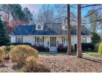 Charming single-story home featuring a well-maintained lawn and mature landscaping at 684 Oak Moss Dr, Lawrenceville, GA 30043