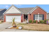 Charming brick home with an attached garage, manicured landscaping, and an American flag at 507 Mockingbird Ln, Loganville, GA 30052