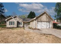 Charming single-story home with a two-car garage and well-maintained landscaping at 70 Oaklake Dr, Covington, GA 30016