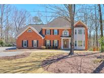 Traditional brick home with manicured lawn and mature trees at 2045 Old Forge Way, Marietta, GA 30068