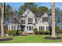 Charming two-story home with well-manicured lawn and mature trees creating a picturesque curb appeal at 3015 Foxhall Overlook, Roswell, GA 30075