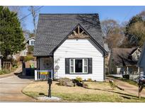 Charming home featuring a classic gable roof, black shutters, and a well-manicured lawn at 974 Grant Se St, Atlanta, GA 30315