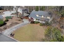 Aerial view of two-story home with a long driveway, mature trees, and a well-maintained lawn at 320 Six Branches Ct, Roswell, GA 30076
