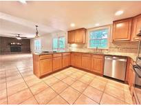 Bright eat-in kitchen featuring granite countertops, stainless appliances, and tile flooring at 320 Six Branches Ct, Roswell, GA 30076