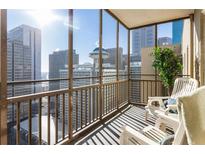 Enjoy amazing city views from this balcony with seating and enclosed with glass at 300 Peachtree Ne St # 24F, Atlanta, GA 30308