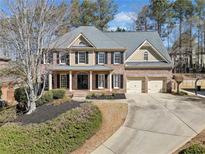 Beautiful two-story brick home with a well-manicured lawn and a spacious two-car garage at 4312 White Hickory Nw Ln, Kennesaw, GA 30152