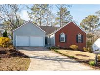 Charming home featuring a two-car garage, well-maintained lawn, and a combination of siding and brick at 4901 October Nw Way, Acworth, GA 30102