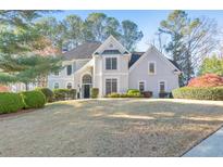 Stately two-story home with a manicured lawn and lush landscaping at 2867 Watchtower Approach Nw, Marietta, GA 30064