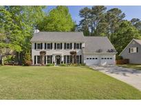 Beautiful two-story home with a well-manicured lawn, three-car garage, and elegant landscaping at 3034 Bristlewood Nw Ln, Marietta, GA 30064