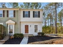 Traditional two-story townhouse with a well-manicured lawn and complementary front door at 601 Wedgewood Way, Atlanta, GA 30350