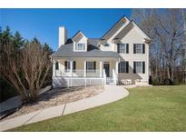 Charming two-story home with a welcoming front porch and well-maintained lawn at 274 Sleepy Hollow Rd, Powder Springs, GA 30127